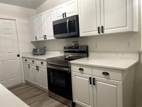 a kitchen with white cabinets and a black stove top oven at Riverside Riviera at Seminole Heights in Tampa