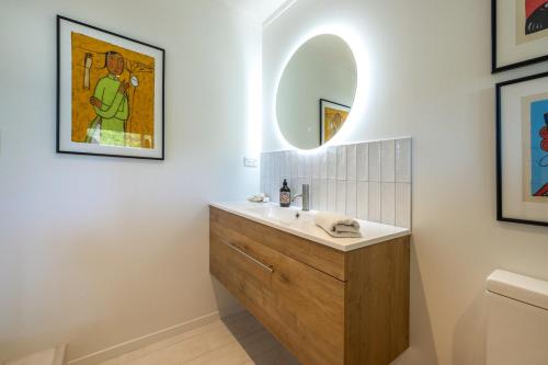 uma casa de banho com um lavatório e um espelho em Relax on Newton em Oneroa