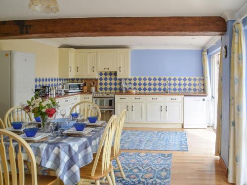 a kitchen with a table and chairs in a kitchen at Fiddledrill Barn in Benniworth