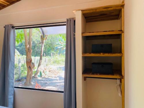 a room with a window and a book shelf at Beautiful 2-bedroom home OR Studio Apartment OPTION in Santa Cruz in Santa Cruz