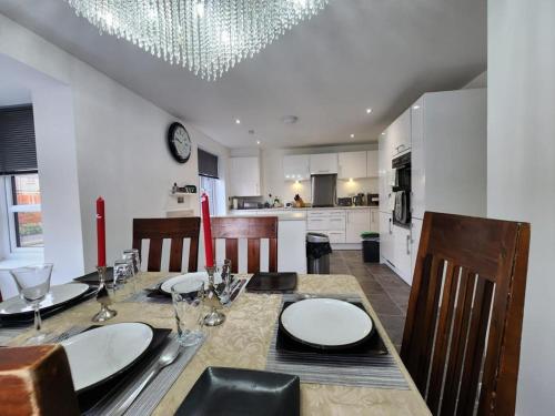a dining room with a table and a kitchen at Spacious 3-bed Luxury Maidstone Kent Home - Wi-Fi & Parking in Kent