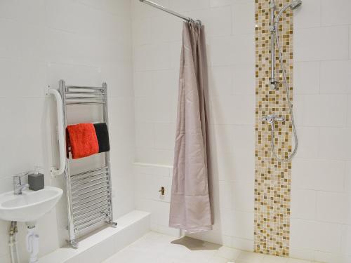 baño blanco con ducha y lavamanos en Romany en Fletching