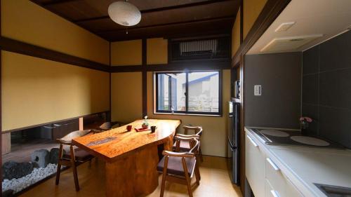 a small kitchen with a wooden table and a window at UFU Kanazawa in Kanazawa