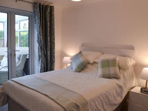 een slaapkamer met een groot bed met 2 kussens bij Glendalough in Hunmanby