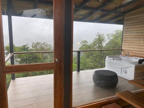 a bathroom with a bath tub on a balcony at Terrabambu Lodge in Mindo