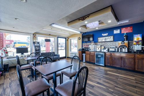 a restaurant with tables and chairs and a counter at Travelodge by Wyndham Jackson North in Jackson