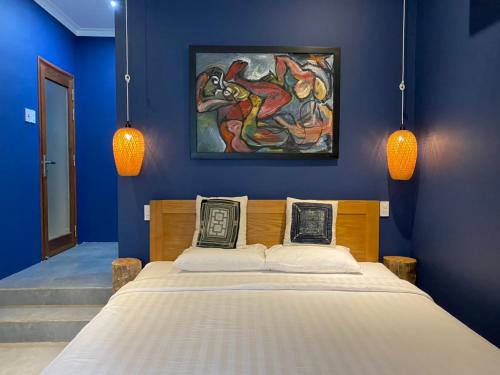 a bedroom with a bed with a painting on the wall at Phan Thiet BeachHouse in Phan Thiet