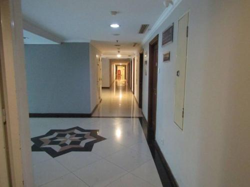 a hallway in a building with a tile floor at Quiet Room Near UNPAR, ITB. Ideal for students in Bandung