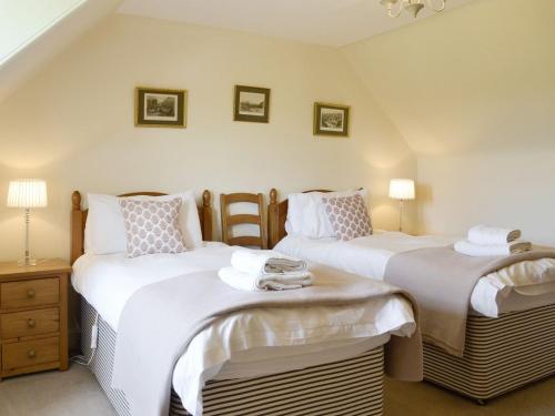 a bedroom with two beds with white sheets at Islabank Farmhouse - Saap in Kirkton of Airlie