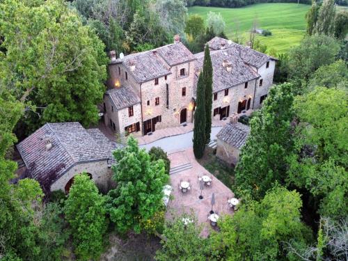 an aerial view of a large house with trees at Charming House in Tuscany with Pool in Monte Castelli