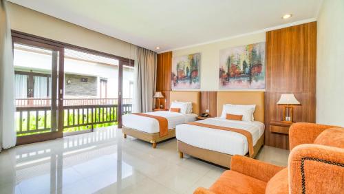 a hotel room with two beds and a balcony at Sotis Villas in Canggu