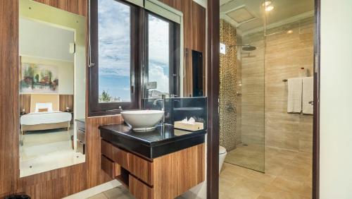 a bathroom with a sink and a toilet and a shower at Sotis Villas in Canggu