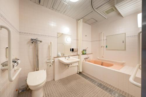 a bathroom with a toilet and a sink and a tub at KAMENOI HOTEL Toba in Toba