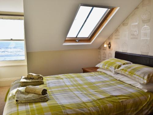 a bedroom with a bed and a skylight at The Nest - 9 The Landings in Filey