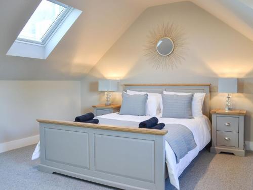 a bedroom with a bed with a mirror on the ceiling at The Carriage House in Upper Poppleton