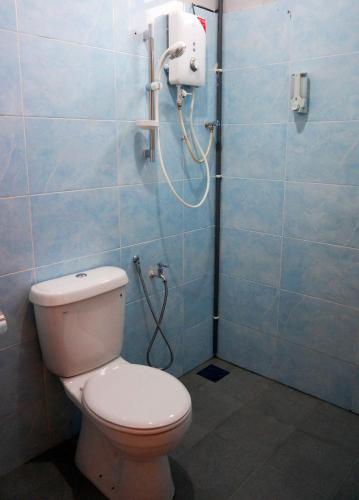 a bathroom with a toilet and a shower at Urbanstay Kuantan in Kuantan