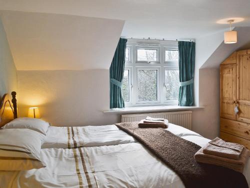 a bedroom with a large bed and a window at Castle View in Wykeham