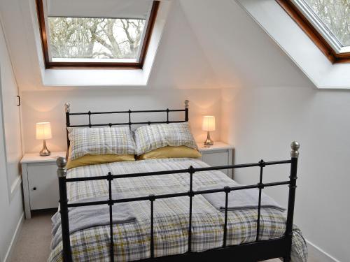 Ένα ή περισσότερα κρεβάτια σε δωμάτιο στο Coachmans Cottage