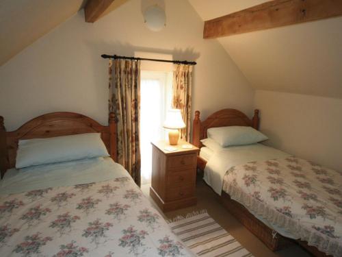 a bedroom with two beds and a window at Spring Cottage-e3846 in Kirk Ireton