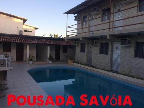 a villa with a swimming pool in pologda savoda at Pousada Savoya in Ilhéus