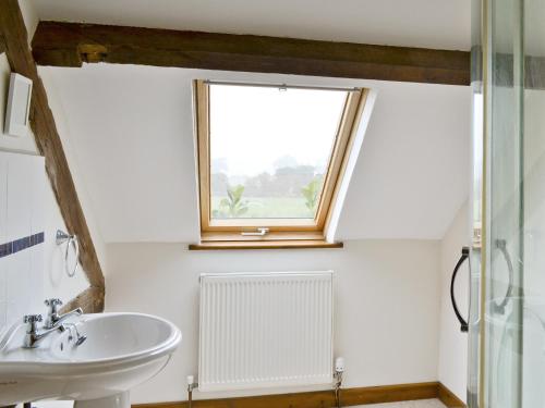 a bathroom with a sink and a window at Bay - E4482 in Ludham