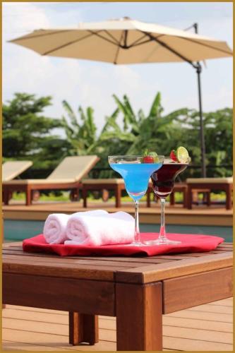 a martini glass sitting on top of a table at The Leisure Hotel in Bang Bo