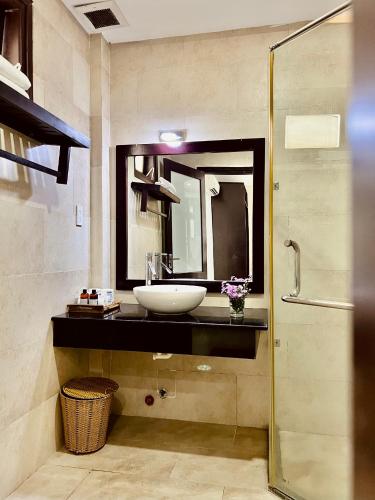 a bathroom with a sink and a mirror at Pearl Beach Homestay - Cua Dai Beach, Hoi An in Hoi An