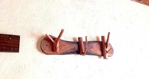 a wooden shoe hanging on a wall at ペンションやいま日和 in Ishigaki Island