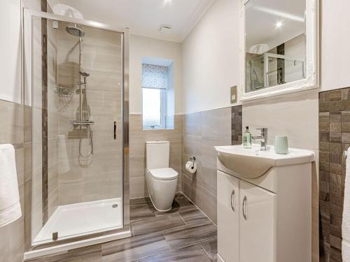 a bathroom with a shower and a toilet and a sink at Gartclach-uk40001 in Gartmore