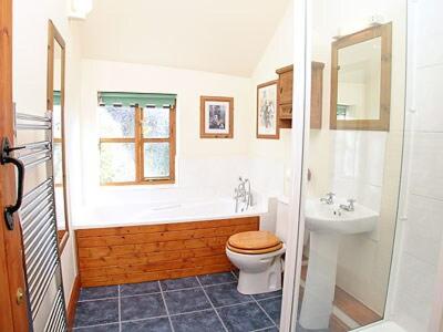 a bathroom with a toilet and a sink at Parlour Cottage in Evershot