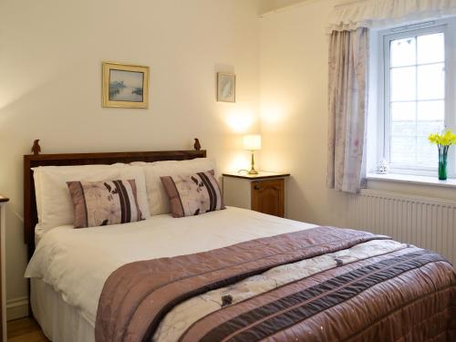 um quarto com uma grande cama branca e uma janela em Stowford Linhay - E3138 em Lewdown