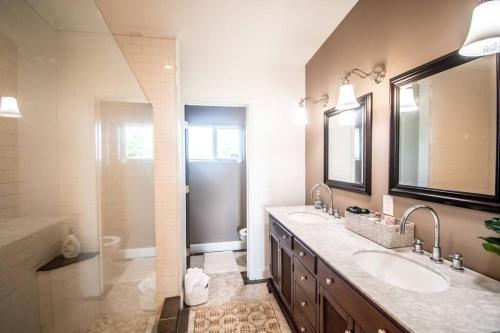 a large bathroom with two sinks and a shower at The Hidden Paradise Home Studio, Downtown City Views, Productions, Families & Large Groups in Baltimore