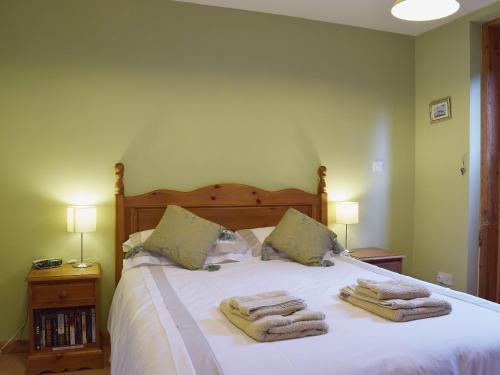 a bedroom with a bed with towels on it at The Gig House in Stonham Aspall