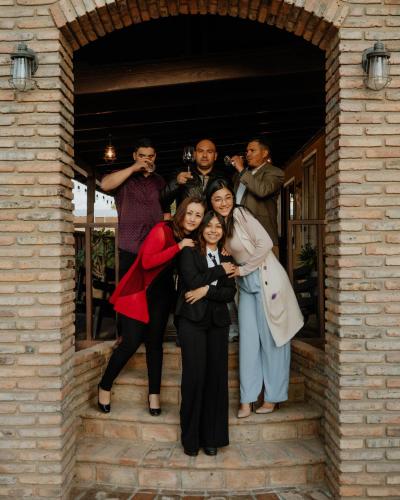 a group of people posing for a picture in a doorway at Cabaña R y A Valle de Guadalupe in Valle de Guadalupe