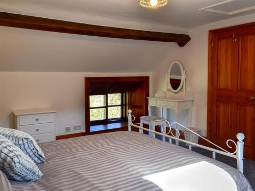 a bedroom with a large bed and a window at Whisperdale Barn in Broxa