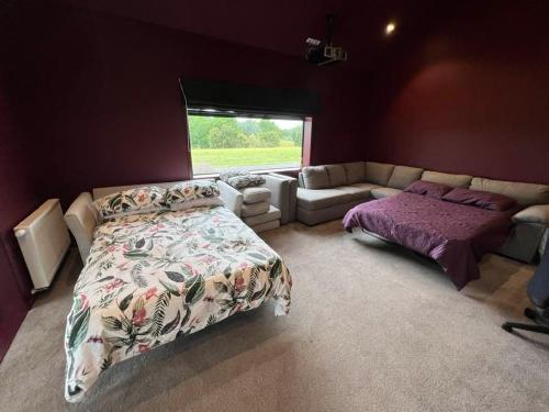 a bedroom with a bed and a couch at The clubhouse in Hamilton
