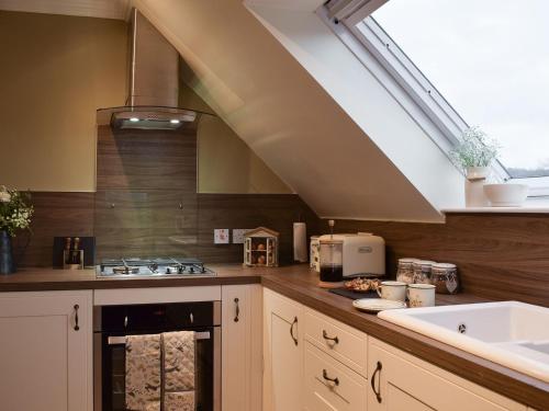 a kitchen with a sink and a stove top oven at Ben Ledi View in Callander