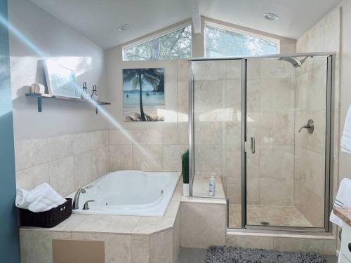a large bathroom with a tub and a shower at Livable C near Lake Washington in Lake Forest Park