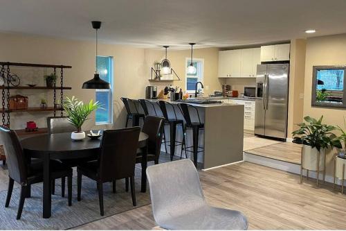 a kitchen and dining room with a table and chairs at Livable D near Lake Washington in Lake Forest Park