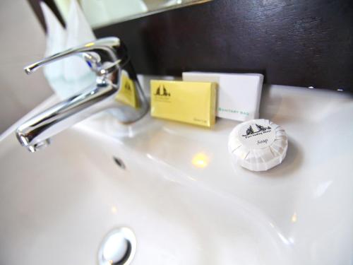 a sink with a faucet and other items on it at Puri Sading Hotel in Sanur