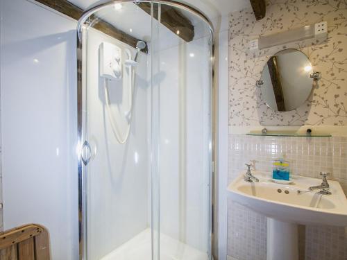 a bathroom with a shower and a sink at Gardeners Bothy in Balnaboth