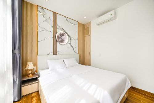 a bedroom with a white bed and a window at Lotus Airport Hotel Saigon in Ho Chi Minh City
