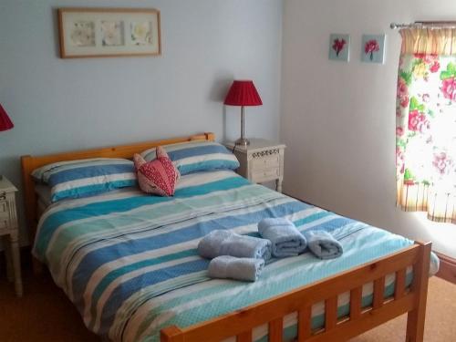 a bedroom with a bed with towels on it at The Shepherds Bothy in Tetford