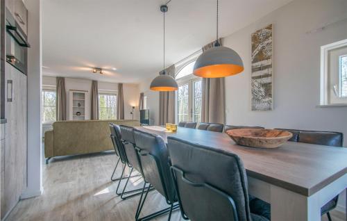 a dining room with a long table and chairs at 4 Bedroom Gorgeous Home In Den Ham in Den Ham