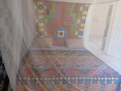 a bed in the corner of a room at Auberge Triskell in Nouakchott