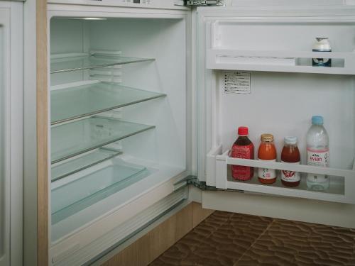 an open refrigerator with drinks in the door at SNOW PEAK FIELD SUITE SPA HEADQUARTERS in Morimachi
