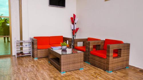 a living room with two chairs and a table at Lebanon Hotel in Kigali