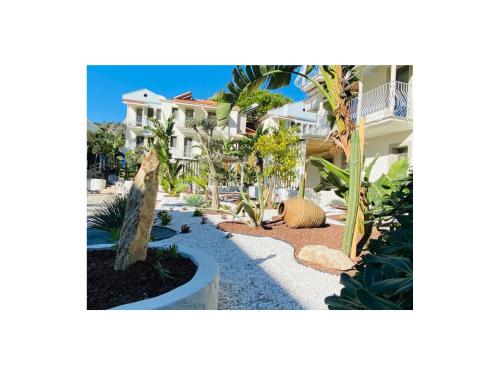 a garden in front of a house at Salonika Suites in Oludeniz