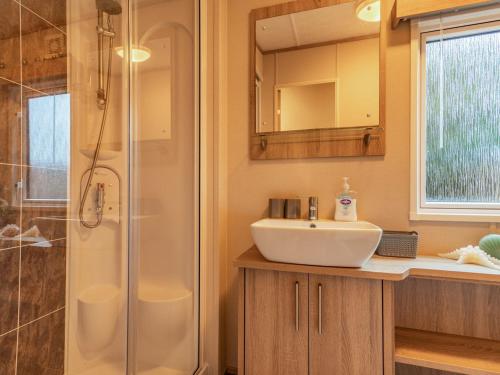 a bathroom with a sink and a shower at Woodlands in Sewerby