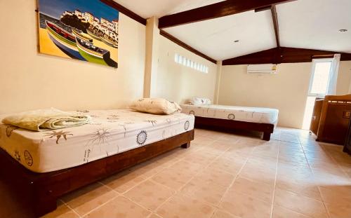 a bedroom with two beds in a room at Paradise Palms in Ko Chang